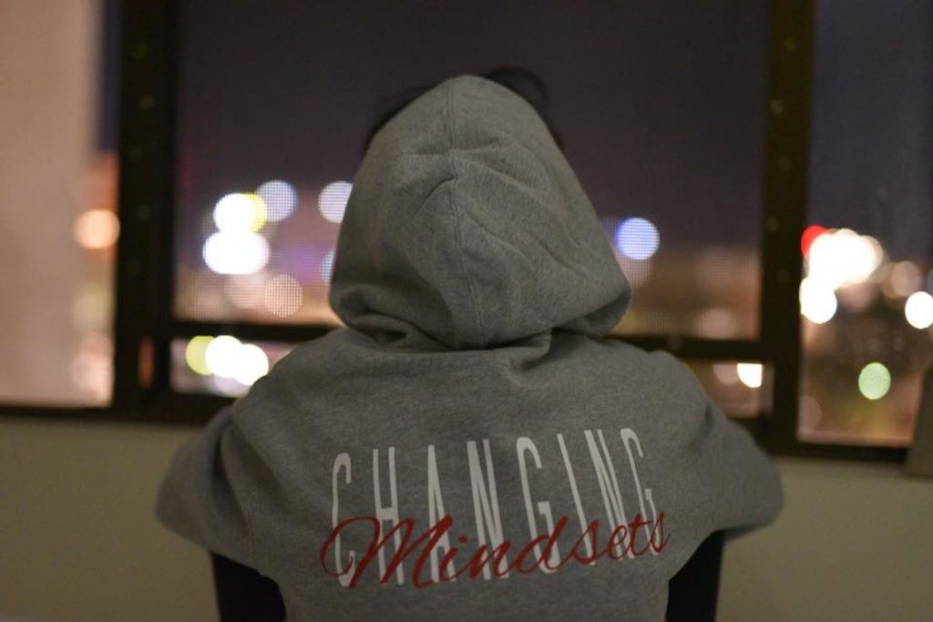 girl with hoodie that says "changing mindsets"