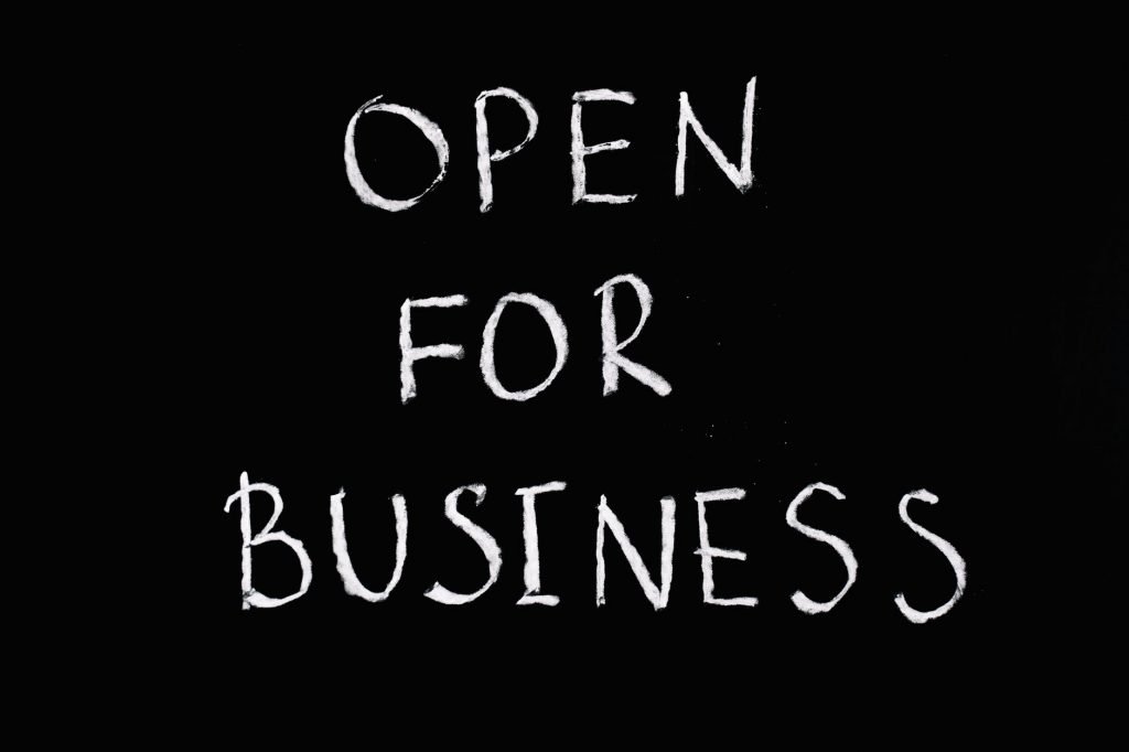open for business lettering text on black background